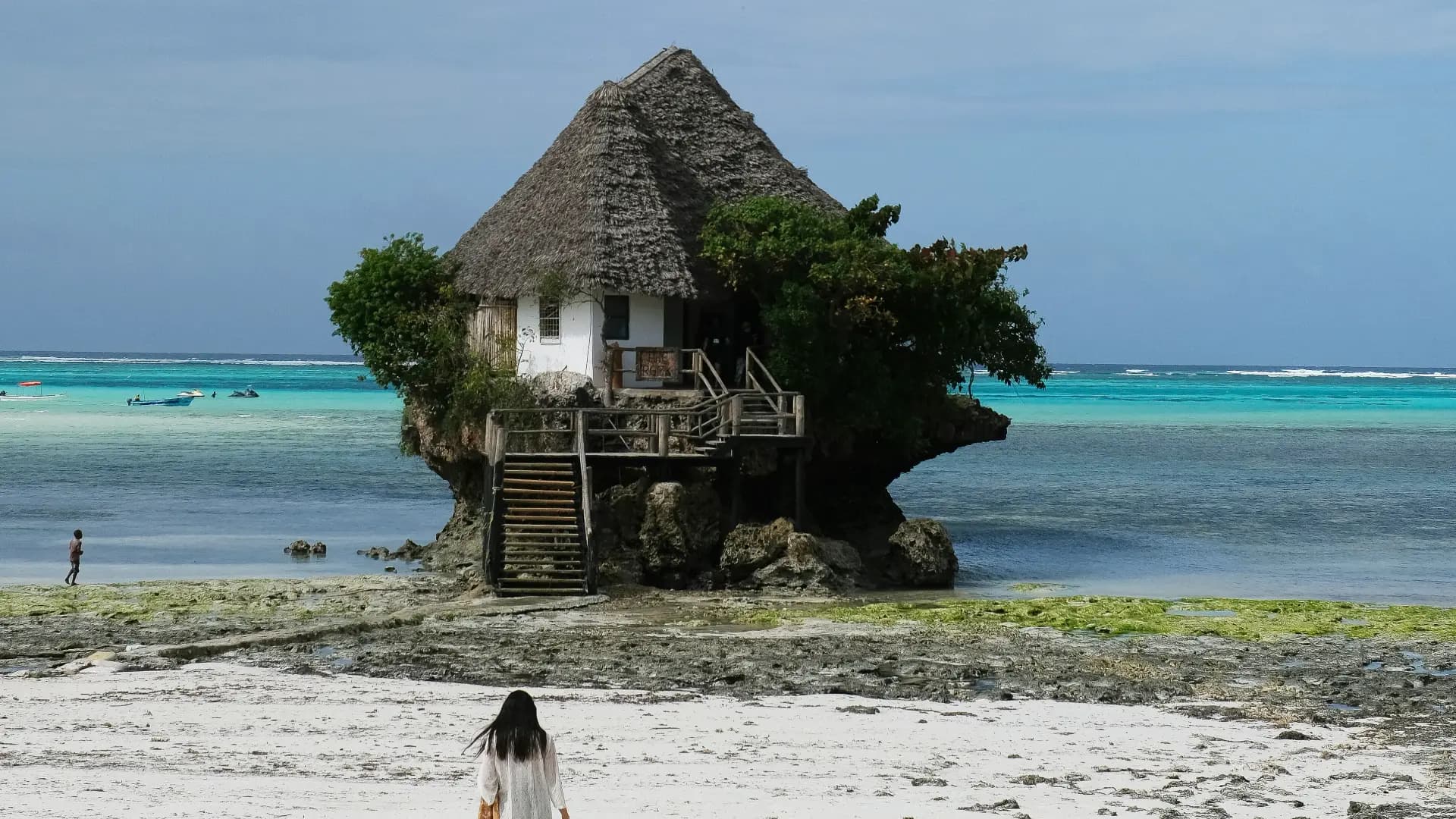 Tropical beach with a unique house on a rock formation