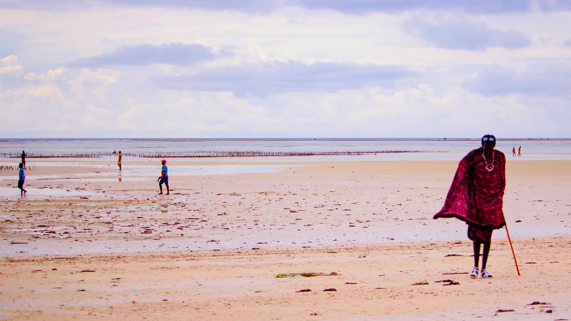 Beach scene with a person in a red cape